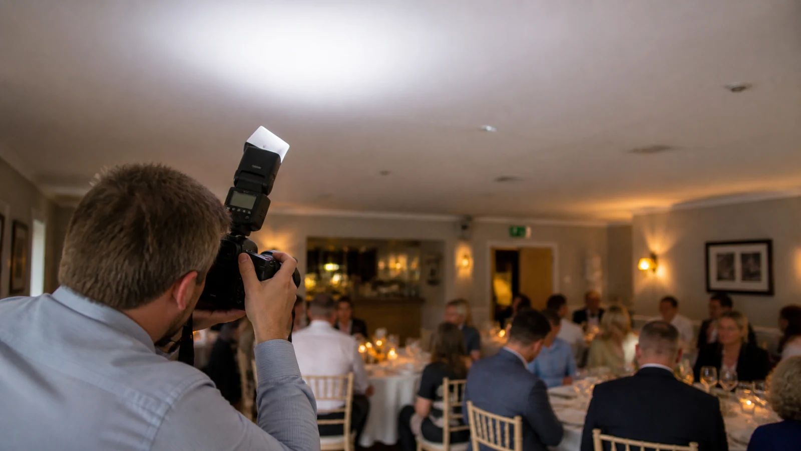 Bounce flash aimed at a pale ceiling during an indoor UK event